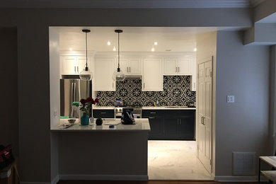 This is an example of a medium sized traditional l-shaped open plan kitchen in DC Metro with a submerged sink, white cabinets, quartz worktops, multi-coloured splashback, ceramic splashback, stainless steel appliances, marble flooring, an island and white floors.