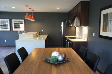 Example of a small trendy galley eat-in kitchen design in Portland with shaker cabinets, dark wood cabinets, stainless steel appliances and an island