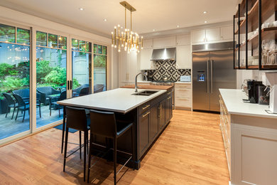 Example of a large eat-in kitchen design in Ottawa with stainless steel appliances and an island