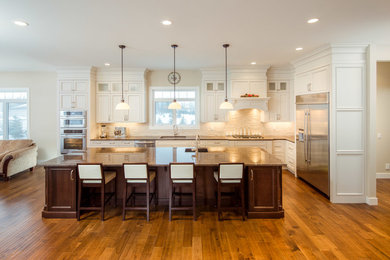 Inspiration for a mid-sized modern l-shaped brown floor eat-in kitchen remodel in Other with an undermount sink, shaker cabinets, white cabinets, granite countertops, white backsplash, stainless steel appliances and an island
