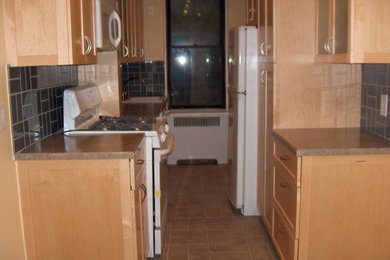 Tuscan brown floor kitchen photo in New York with brown countertops