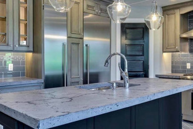 Kitchen - mid-sized traditional l-shaped porcelain tile and gray floor kitchen idea in DC Metro with an undermount sink, beaded inset cabinets, beige cabinets, concrete countertops, gray backsplash, subway tile backsplash, stainless steel appliances, an island and gray countertops