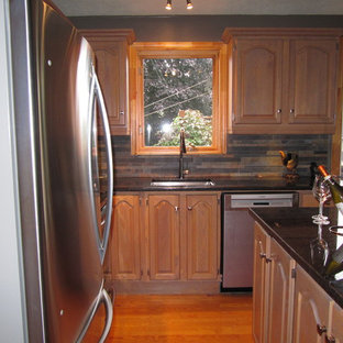 Small country l-shaped eat-in kitchen in Montreal with an undermount sink, louvered cabinets, light wood cabinets, granite benchtops, multi-coloured splashback, porcelain splashback, stainless steel appliances, light hardwood floors and with island.