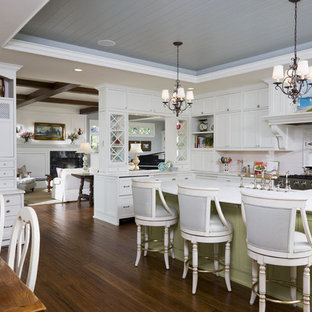 Inspiration for a large timeless l-shaped dark wood floor eat-in kitchen remodel in Minneapolis with shaker cabinets, white cabinets, white backsplash, stainless steel appliances, an island, marble countertops and subway tile backsplash