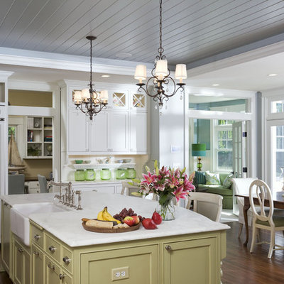 Eat-in kitchen - large traditional l-shaped dark wood floor eat-in kitchen idea in Minneapolis with a farmhouse sink, shaker cabinets, white cabinets, marble countertops, white backsplash, subway tile backsplash, stainless steel appliances and an island