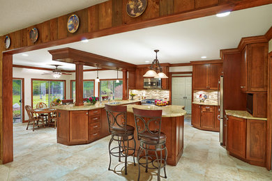 Example of a large classic galley ceramic tile eat-in kitchen design in Cleveland with a double-bowl sink, recessed-panel cabinets, medium tone wood cabinets, granite countertops, metallic backsplash, ceramic backsplash, paneled appliances and two islands