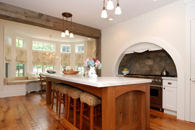 Eat-in kitchen - large rustic l-shaped medium tone wood floor eat-in kitchen idea in New York with stainless steel appliances, recessed-panel cabinets, white cabinets, a drop-in sink, gray backsplash and an island