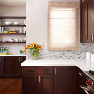 Contemporary kitchen remodeling - Inspiration for a contemporary kitchen remodel in San Francisco with shaker cabinets, dark wood cabinets, quartz countertops, white backsplash and stone tile backsplash