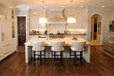 Inspiration for a mid-sized timeless single-wall dark wood floor eat-in kitchen remodel in Nashville with white cabinets, paneled appliances, recessed-panel cabinets, marble countertops, an island, a farmhouse sink, white backsplash and stone tile backsplash