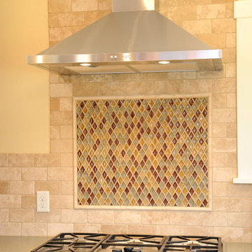 Kitchen Stove with Tile Backsplash and Stainless Steel Hood