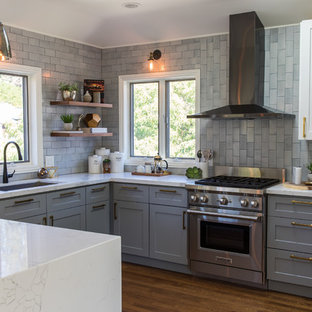 Transitional kitchen ideas - Inspiration for a transitional u-shaped medium tone wood floor and brown floor kitchen remodel in San Francisco with an undermount sink, louvered cabinets, gray cabinets, gray backsplash, stainless steel appliances and turquoise countertops