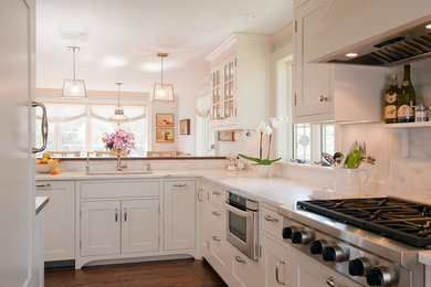 Example of a transitional kitchen design in Boston with an undermount sink, shaker cabinets, white cabinets, white backsplash, stone slab backsplash and stainless steel appliances