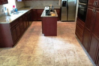 Kitchen - ceramic tile kitchen idea in Manchester with an island