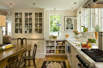 Eat-in kitchen - country eat-in kitchen idea in Burlington with a drop-in sink, open cabinets, white cabinets, white backsplash, marble countertops and stone slab backsplash
