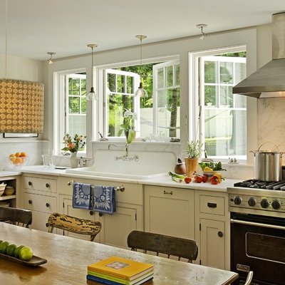 Inspiration for a timeless eat-in kitchen remodel in Burlington with a drop-in sink, beaded inset cabinets, marble countertops, white backsplash, stone slab backsplash, black appliances and beige cabinets