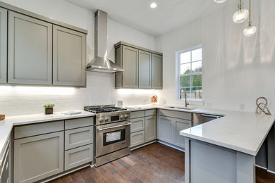 Inspiration for a small transitional u-shaped light wood floor and brown floor open concept kitchen remodel in Austin with a single-bowl sink, shaker cabinets, gray cabinets, quartz countertops, white backsplash, subway tile backsplash, stainless steel appliances and yellow countertops