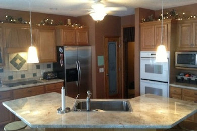 ミネアポリスにある中くらいなトラディショナルスタイルのおしゃれなキッチン (シングルシンク、淡色木目調キャビネット、セメントタイルのキッチンパネル、シルバーの調理設備) の写真