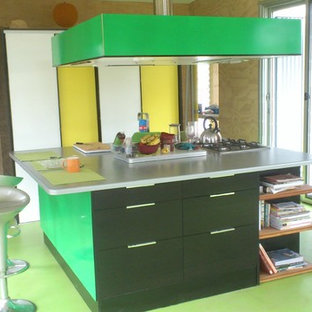 Photo of a small contemporary kitchen in Sydney with an undermount sink, flat-panel cabinets, laminate benchtops, panelled appliances, painted wood floors, with island, green floor and green benchtop.