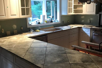 Mid-sized elegant u-shaped terra-cotta tile and red floor eat-in kitchen photo in Boston with a drop-in sink, shaker cabinets, white cabinets, tile countertops, stainless steel appliances, two islands and gray countertops