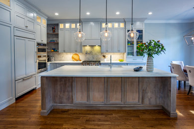 Inspiration for a large contemporary u-shaped dark wood floor and brown floor kitchen remodel in Charlotte with an undermount sink, recessed-panel cabinets, gray cabinets, marble countertops, gray backsplash, porcelain backsplash, stainless steel appliances, an island and white countertops