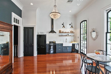 Eat-in kitchen - small transitional single-wall light wood floor and beige floor eat-in kitchen idea in New Orleans with a farmhouse sink, recessed-panel cabinets, gray cabinets, quartz countertops, black appliances, no island and white countertops