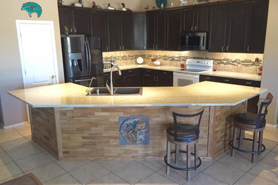 Mid-sized trendy l-shaped ceramic tile and beige floor eat-in kitchen photo in Phoenix with raised-panel cabinets, dark wood cabinets, granite countertops, an island, a drop-in sink, beige backsplash, matchstick tile backsplash and stainless steel appliances