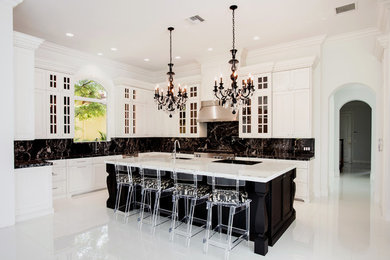 Open concept kitchen - large contemporary l-shaped marble floor and white floor open concept kitchen idea in Other with an undermount sink, recessed-panel cabinets, white cabinets, marble countertops, black backsplash, stone slab backsplash, an island and stainless steel appliances