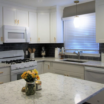 Kitchen - white cabinetry, brush brass hardware and granite counter tops