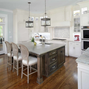 Kitchen with a large island showcasing a metal top