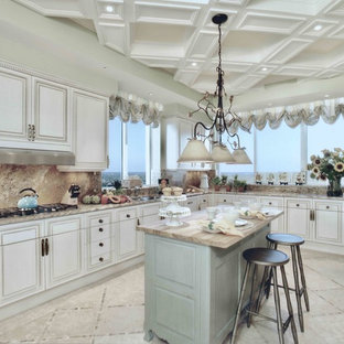 Inspiration for an expansive traditional l-shaped eat-in kitchen in Miami with an undermount sink, raised-panel cabinets, beige cabinets, granite benchtops, brown splashback, stone slab splashback, stainless steel appliances, travertine floors, with island, beige floor and brown benchtop.