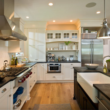 Kitchen with Antique White Cabinets and Black Island with White Farmhouse Sink