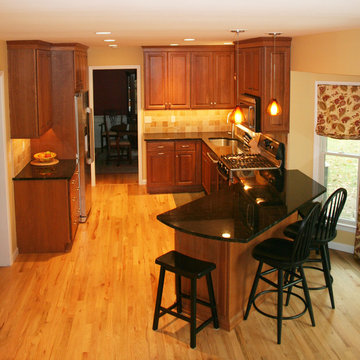 Kitchen with Black Counters and Light Wood Floors