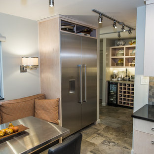 Inspiration for a small contemporary u-shaped eat-in kitchen in Other with a double-bowl sink, flat-panel cabinets, light wood cabinets, granite benchtops, green splashback, slate splashback, stainless steel appliances, slate floors, no island and green floor.