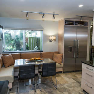 Small contemporary u-shaped eat-in kitchen in Other with a double-bowl sink, flat-panel cabinets, light wood cabinets, granite benchtops, green splashback, slate splashback, stainless steel appliances, slate floors, no island and green floor.