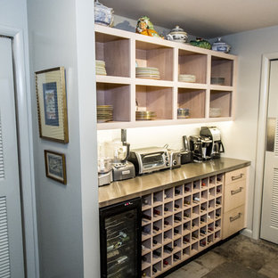Inspiration for a small contemporary u-shaped eat-in kitchen in Other with a double-bowl sink, flat-panel cabinets, light wood cabinets, granite benchtops, green splashback, slate splashback, stainless steel appliances, slate floors, no island and green floor.