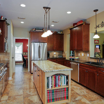 Kitchen with dark wood cabinets and light wood island