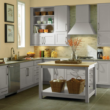 Kitchen with gray cabinetry and pastel accent walls and tile-work