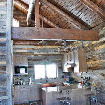 Kitchen with Reclaimed Wood Walls and Natural Log Beams