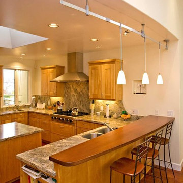 Kitchen with solid wood bar. Curved wall matches curved bar.