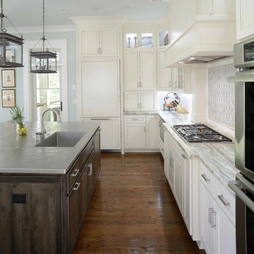 Kitchen with white cabinetry and dark hardwood island