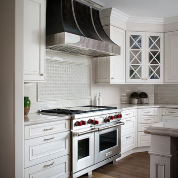 Kitchen with White Cabinets and Stainless Steel Range and Hood