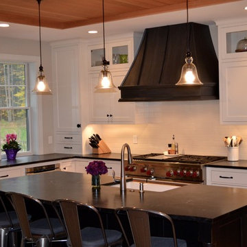 Kitchen with White Cabinets with Black Range Hood