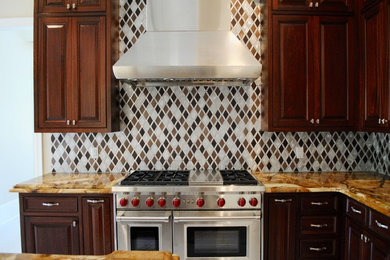 Inspiration for a huge eclectic u-shaped marble floor enclosed kitchen remodel in New Orleans with an undermount sink, raised-panel cabinets, dark wood cabinets, granite countertops, metallic backsplash, metal backsplash, stainless steel appliances and an island