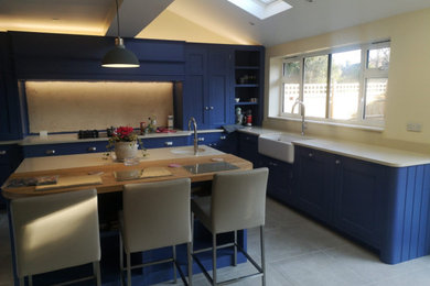 Inspiration for a country kitchen in Kent with quartz worktops, an island and beige worktops.