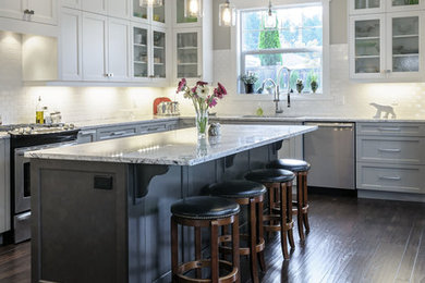 Inspiration for a large transitional u-shaped dark wood floor eat-in kitchen remodel in Vancouver with shaker cabinets, gray cabinets, granite countertops, white backsplash, subway tile backsplash, stainless steel appliances and an island