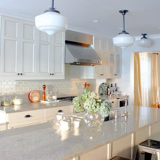 Inspiration for a timeless kitchen remodel in Chicago with stainless steel appliances, subway tile backsplash, recessed-panel cabinets, white cabinets, white backsplash and granite countertops