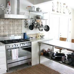 Kitchen - eclectic kitchen idea in Chicago with stainless steel appliances, white cabinets and multicolored backsplash