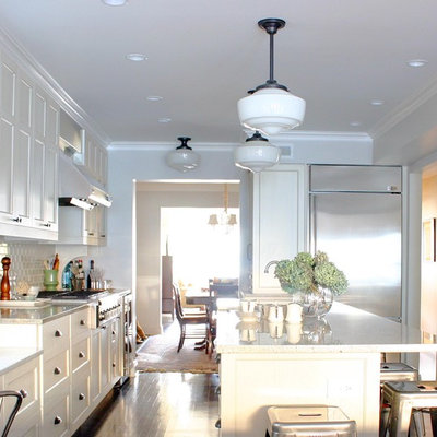 Elegant kitchen photo in Chicago with stainless steel appliances, shaker cabinets, white cabinets, white backsplash, subway tile backsplash and granite countertops