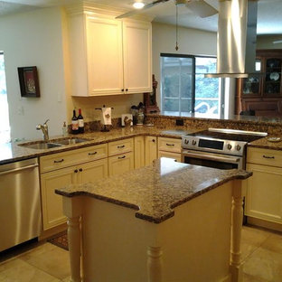Mid-sized traditional open concept kitchen ideas - Open concept kitchen - mid-sized traditional l-shaped ceramic tile and brown floor open concept kitchen idea in Tampa with a double-bowl sink, recessed-panel cabinets, white cabinets, granite countertops and an island