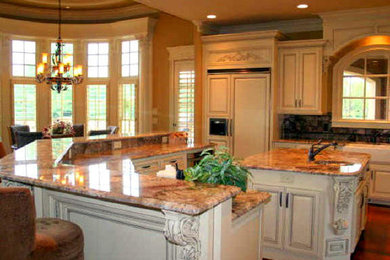 Large kitchen photo in Atlanta with white cabinets, stainless steel appliances and an island